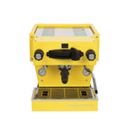 A La Marzocco Linea Mini espresso machine with a white body, black accents, and a stainless steel top.